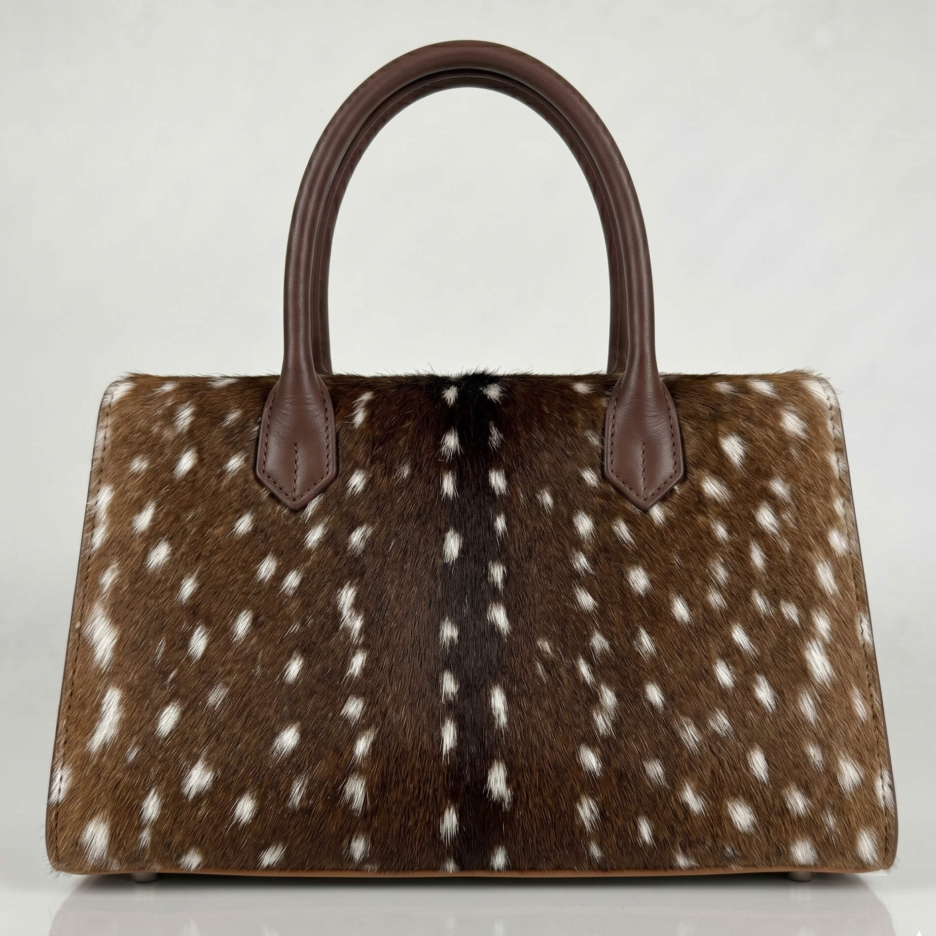 Handbag with brown and white spotted pattern on a white background